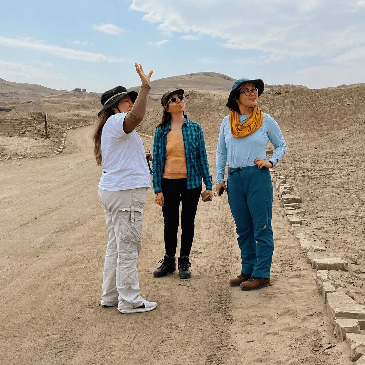 Tour guide with travelers at Pachacamac archaeological sanctuary near Lima