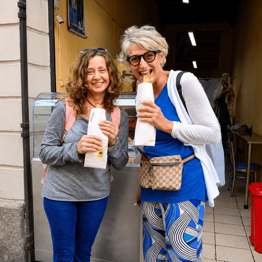 Travelers enjoying local treats during a Lima walking tour