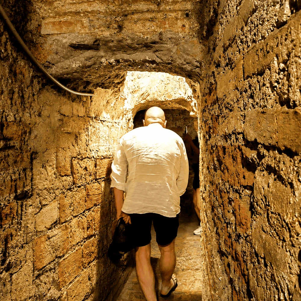 Narrow underground tunnel inside the San Francisco catacombs in Lima
